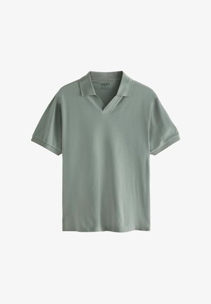 Polo krekls maigi zaļā audumā, ar v-veida apkakli, īsām piedurknēm un brīvu piegriezumu. Vienkāršs dizains bez redzamām rakstēm.