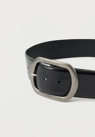 Svart lærbelte med en rektangulær metallspenne hvor ordet "WEEKEND" er preget. Det har flere justeringshull langs stroppen.