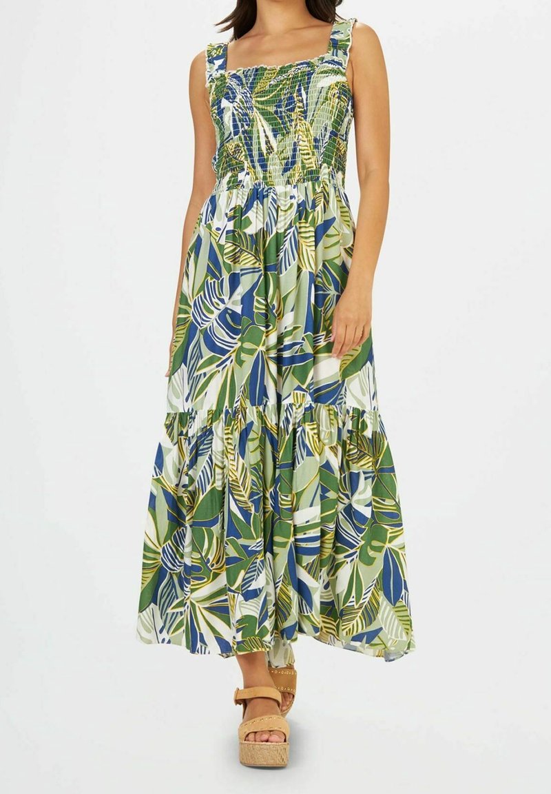 Robe longue avec corsage froncé, imprimé de feuilles vertes et bleues, et jupe à volants à étages. Confectionnée en tissu léger avec bretelles ajustables.