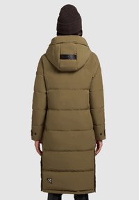 Olive green long puffer coat with an adjustable hood, snap button cuffs, and logo patch. Features a quilted design and side slits.