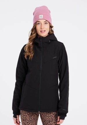 Veste d'extérieur noire avec une fermeture éclair et une capuche, en tissu doux et avec des détails subtils. Associée à des leggings à imprimé léopard et un bonnet rose.