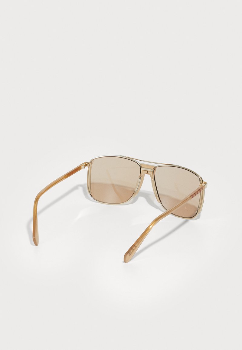Sunglasses med lysebrune rektangulære linser og gennemsigtige lysebrune stel. Slanke stænger har et diskret stribet mønster.