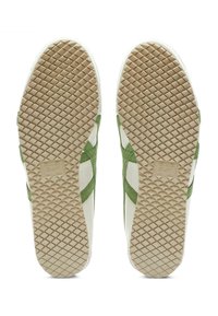 Tenisky s bílým koženým svrškem a zelenými semišovými akcenty. Texturované, gumové podrážky v barvě gumy s diamantovým vzorem pro lepší grip.