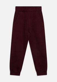 Maroon joggerbyxor med elastisk midja, sidofickor och ribbade mudd på vit bakgrund.
