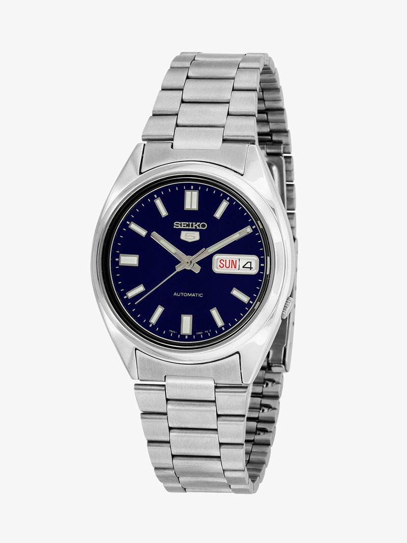 Seiko automatic wristwatch with silver metal band, dark blue face, silver hour markers, and day-date display showing Sunday 4.
