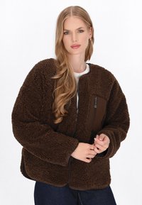 Brown fleece jacket with a zippered chest pocket, textured fabric, and ribbed cuffs. Features a relaxed fit and slightly cropped length.