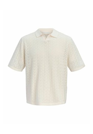 Polo en maille crème à manches courtes avec motif perforé en zigzag et col plié.