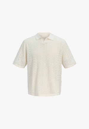 Polo en maille crème à manches courtes avec motif perforé en zigzag et col plié.