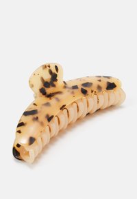 Tortoiseshell hair clip in transparent plastic with brown and black speckles, featuring a curved design and multiple gripping teeth.