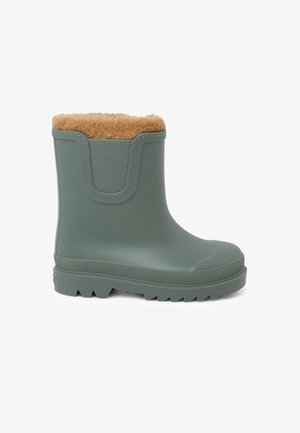 Grüner gummierter Knöchelstiefel mit braunem Kunstfellfutter, strukturiertem Seitenpaneel und robustem Sohlenprofil mit tiefen Rillen für besseren Halt.