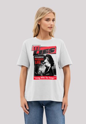 White t-shirt featuring a black and red graphic print with the text "GN'R LIES" and an illustration of a woman drinking. Short sleeves.