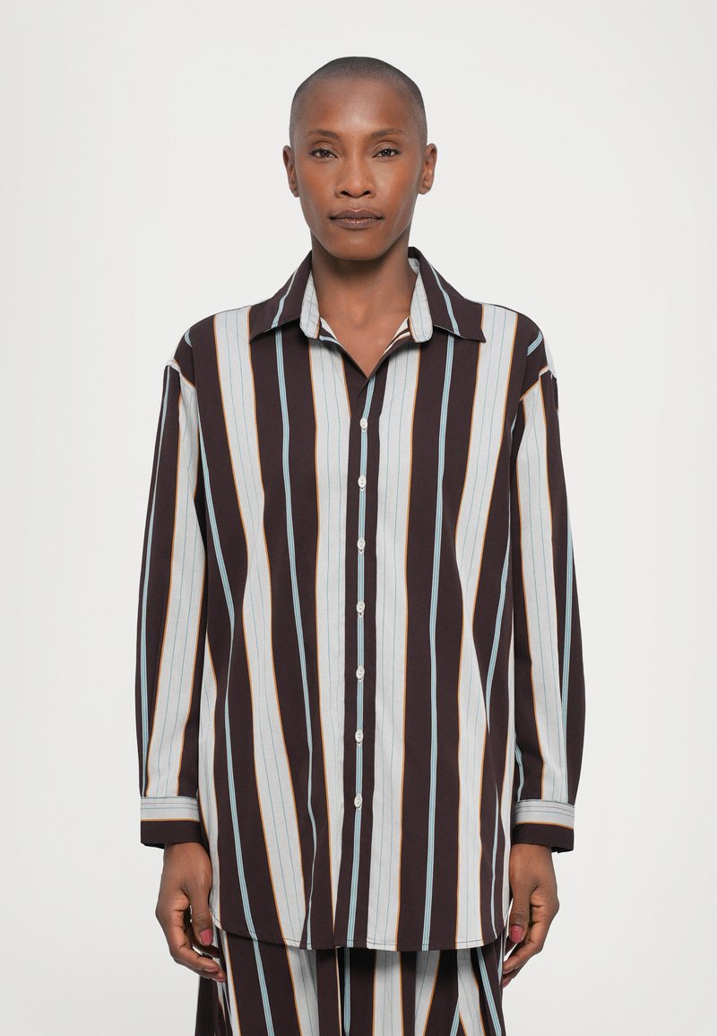 Button-up shirt in brown, blue, and orange vertical stripes; features a collar, long sleeves, and a relaxed fit. Smooth fabric texture.