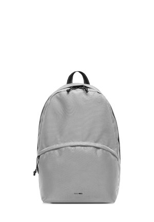 Gray backpack made of durable fabric, with a rounded shape, drawstring closure, and a front zippered pocket. Features black accents.