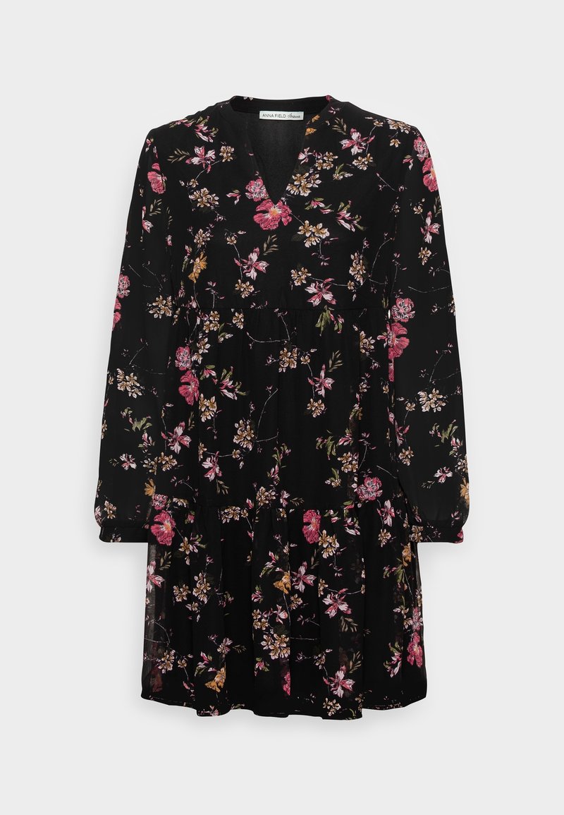 Robe noire à manches longues avec motif floral rose et jaune, encolure en V et jupe à volants.