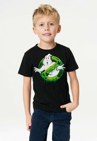Black T-shirt featuring a white ghost graphic inside a green, dripping circle. Short sleeves and a crew neckline, made of cotton.