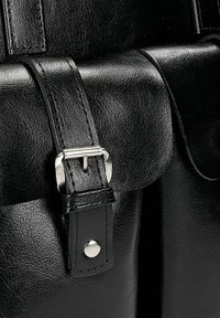 Borsa in pelle nera con una finitura lucida, fibbia in metallo argentato e dettaglio a pulsante a scatto. Il design presenta accenti di cuciture visibili.