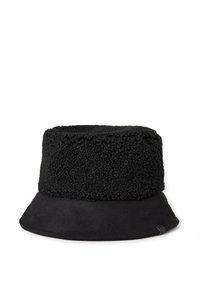 Černý klobouk typu bucket s plyšovým, texturovaným horním dílem a hladkým, matným dolním lemem. Viditelná vnitřní etiketa zdůrazňující odolnost a design.