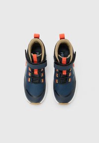Pair of navy blue and black toddler shoes with orange pull tabs, black elastic laces, beige lining, and white soles on plain background.