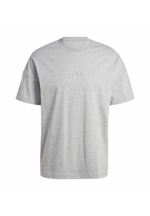 T-shirt grigia a maniche corte realizzata in misto cotone con collo rotondo e logo in rilievo sul petto. Vestibilità rilassata con texture liscia.