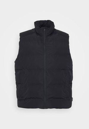 Črna puffer brezrokavnik z visokim ovratnikom, sprednjim zadrgo in stranskimi žepi. Gladka tekstura z quilted oblikovanjem za izolacijo.