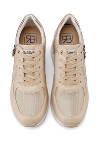 Sneaker beige con parte anteriore in tessuto testurizzato, chiusura con lacci e zip laterale. Include un logo sulla linguetta e dettagli metallici.