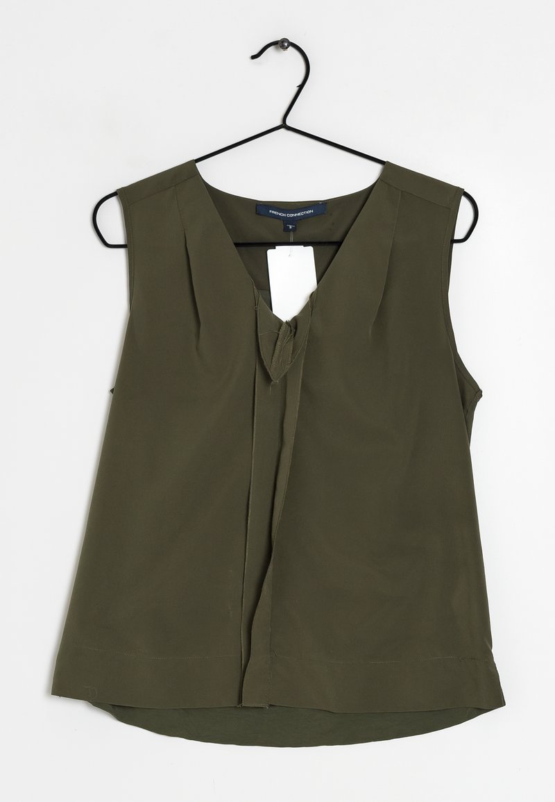 Olive green sleeveless blouse with V-neck, pleat detailing at the front, and a straight hem. Made from lightweight fabric. Hangs on a black hook.