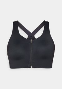 Svart sports-bh med glidelås foran og kryssende stropper. Laget av glatt stoff med en tettsittende passform og minimale sømmer.