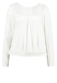 Chemisier blanc à manches longues avec tissu texturé, panneaux en dentelle sur le haut de la poitrine et l'ourlet, et un col rond.