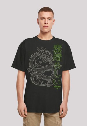 Black t-shirt featuring a gray dragon graphic with green Japanese text. Short sleeves, relaxed fit, cotton fabric, detailed dragon design.
