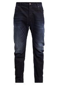 Mörkblå denimjeans med en gradvis ljusare effekt mot knäna, fem fickor och en knappstängning i midjan.