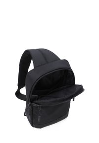Zaino nero realizzato in nylon resistente, con una struttura imbottita, scomparto principale con cerniera e spallacci regolabili. Design minimalista senza loghi visibili.