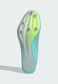 Sport shoe sole in light blue and green gradient design. Features six metal studs and textured rubber for traction. Smooth finish.