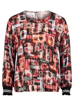 Blouse à manches longues avec motif abstrait de lettres superposées en rouge, noir, beige et bleu clair, dotée de poignets rayés noirs et blancs.