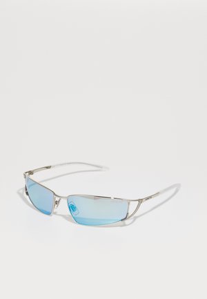 Sunglasses with silver metal frame, blue-tinted lenses, and sleek rectangular shape. Features thin arms and subtle branding on the side.