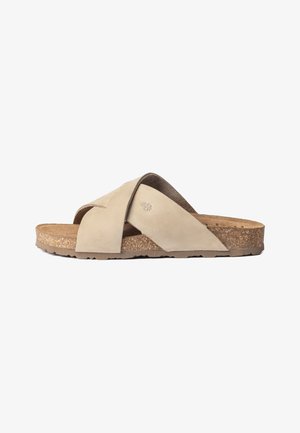 Sandalo beige in suede con fasce incrociate e soletta in sughero, caratterizzato da una suola morbida sagomata e una suola esterna texturizzata per una maggiore aderenza.