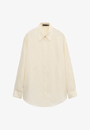 Camicia crema a maniche lunghe con bottoni, collo a punta e patta nascosta, distesa su uno sfondo bianco.