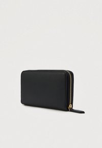 Black rectangular leather wallet with gold zipper and pull tab, angled view on plain light background.