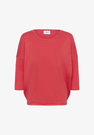 Koralų raudonumo laisvo silueto palaidinė su apvalia iškirpte, trijų ketvirčių rankovėmis, ribbiniu raštu ir minkšta tekstūra. Ant iškirptės pritvirtinta etiketė „Saint“.