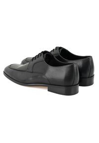 Schwarze Lederschuhe mit glatter Textur, runder Zehenform, Schnürdesign und einer niedrigen, flachen Gummisohle. Die Rückansicht betont die schlanke Silhouette.