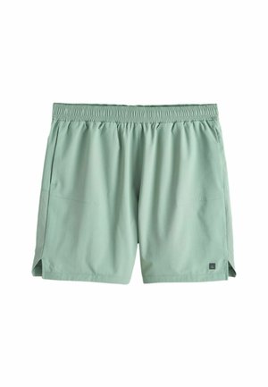 Hellgrüne Herren-Sportshorts mit elastischem Bund und kleinen Seitenschlitzen, flach auf einem weißen Hintergrund ausgelegt.