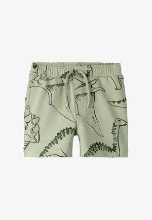 Shorts pour enfants vert clair avec taille élastique et dessins de dinosaures en lignes vert foncé sur toute la surface.