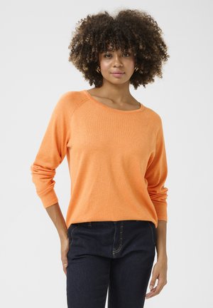 Orange knit sweater with a wide neckline, long sleeves, and ribbed cuffs, paired with dark blue jeans. Smooth texture and relaxed fit.