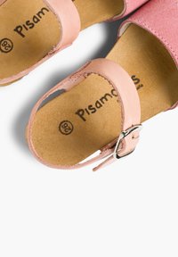 Pink leather sandals with a soft texture, featuring an ankle strap with a metal buckle and a natural cork footbed. Logo printed inside.