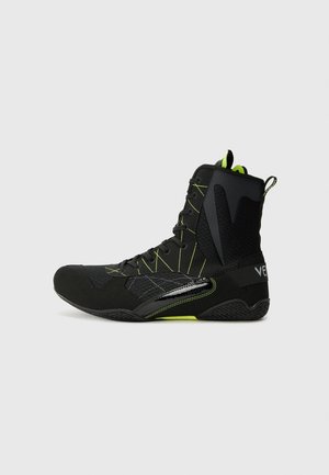 Pantofi sport înalte, de culoare neagră, cu accente verzi neon. Dispun de un material texturat la partea superioară, șireturi securizate și o talpă din cauciuc cu un model distinctiv.