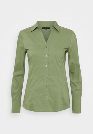 Jasnozielona koszula na długi rękaw z guzikami, kołnierzykiem i dopasowaną talią, prezentowana na białym tle.