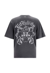 Camiseta oversize en gris carbón con un gran gráfico de calavera blanca y pulpo en la parte de atrás. Mangas cortas y escote redondo.