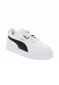 White sneaker made of leather with a black stripe and gold logo. Rounded toe, lace-up front, and textured sole. Minimal perforations on the toe.