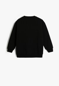 Sudadera negra con cuello redondo, puños y dobladillo acanalados. Textura suave, mangas largas y un ajuste relajado. Sin logotipos ni diseños visibles.