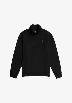 Pullover in pile nero con colletto a mezza zip, polsini elastici e logo sul petto. Tessuto morbido e vestibilità rilassata.