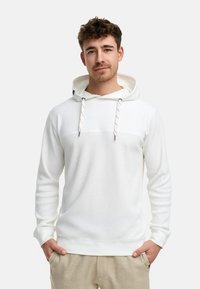 Witte hoodie met geribbelde textuur, trekkoord en een contrasterend paneelontwerp. Kenmerkt een ontspannen pasvorm en geribbelde manchetten.